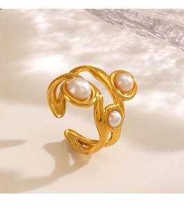 Detail of a vintage gold irregular ring with three elegant pearls and wave light shadows