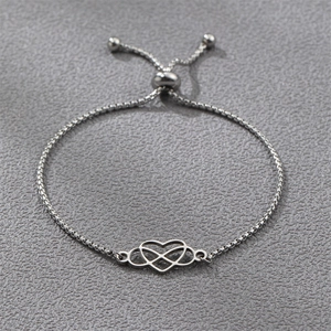 Detail of silver adjustable box chain bracelet with heart and infinity symbol charm
