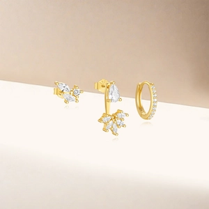 Macro detail of gold S925 silver earring set featuring sparkling marquise cubic zirconia