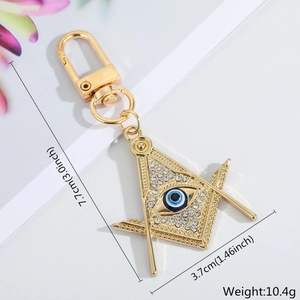 Detailed size view of gold evil eye keychain with rhinestones, 7.7cm length measurement