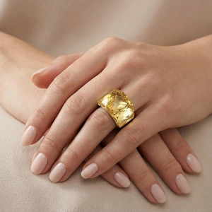 Macro shot of an elegant silver ring with a large square emerald-cut yellow crystal gemstone