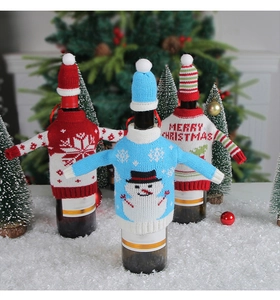 Close-up of snowman and snowflake knitted wine bottle covers with mini matching hats