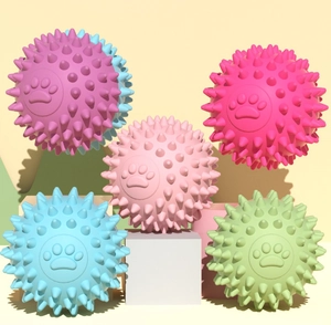 Detailed view of hollow TPR pet toy balls with spiky texture and footprint patterns