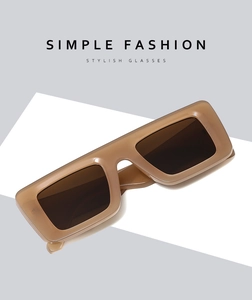 Close-up of brown tortoise shell oversized rectangular sunglasses with glossy finish