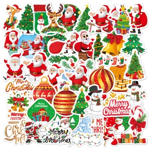 Flat lay of diverse holographic laser Christmas stickers with Santa and reindeer designs