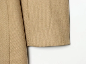 Detail of khaki twill blazer cuff showing premium textured fabric and stitching