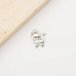 Detailed close-up of a silver stainless steel cat pendant with a polished finish and loop
