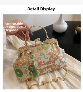 Detail view of green embroidery silk bag with golden metal clasp and jade tassel