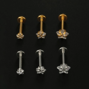 Macro detail of star-shaped 316L stainless steel labret studs with AAA zircon inlays