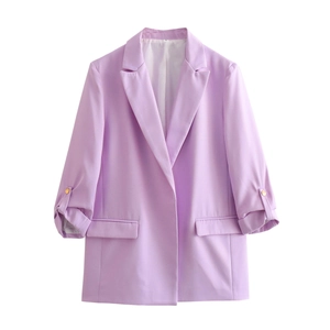 Detail of light purple blazer featuring notched lapels, ruched sleeves, and gold buttons