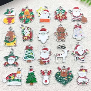 Close-up of enamel Christmas charms featuring Santa and reindeer for DIY jewelry making