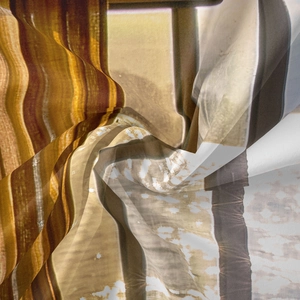 Detail of bohemian tapestry fabric showing silk texture and artistic wave patterns