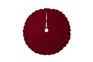 Detail of red knitted Christmas tree skirt with ruffled edges and fixing straps