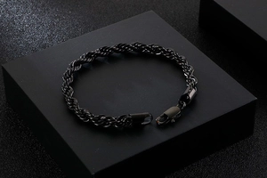 Close-up of a 6mm black braided twist rope bracelet with a classic lobster clasp