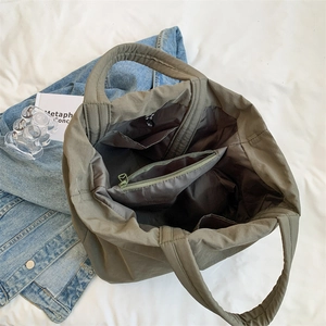 Army green nylon tote bag for women showing spacious interior with zipper pockets