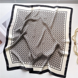 Detail of 70cm silk-like scarf with black and white geometric diamond pattern textures
