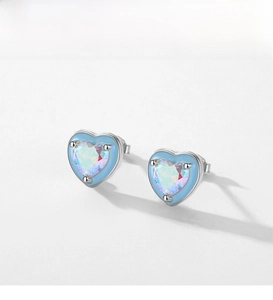 Macro detail of S925 sterling silver heart earrings with colorful opal stone and blue enamel