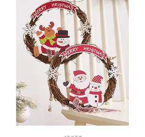 Close-up of rustic Christmas wreath with Merry Christmas banner and cute wooden ornaments