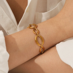 Close-up of 18K gold plated stainless steel oval link chain bracelet on a wrist