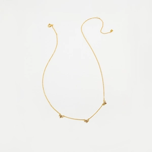 Close-up of golden S925 silver necklace featuring three sparkling leaf-shaped pendants