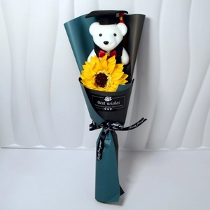 Detail of graduation teddy bear with sunflower in teal and black gift wrapping