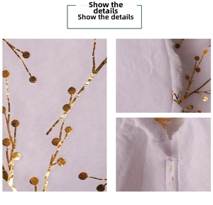 Macro detail of white faux fur Christmas tree skirt with gold foil branch patterns
