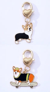 Detail of Corgi enamel dog pendants with heart-shaped spring clasps and gold alloy base