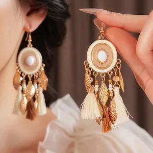 Vintage enamel tassel earrings with gold leaf accents and bohemian ethnic style details