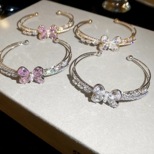 Macro shot of sparkling zircon butterfly bracelets with pink crystals and pearls