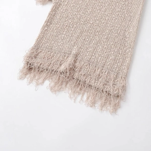 Fashionable light beige knitted vest featuring a thick texture and long fringe hem details