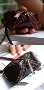 Macro shot of vintage veg-tan leather zipper key pouch with contrast stitching