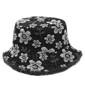 Frayed edge floral denim bucket hat with white flower embroidery on black fabric