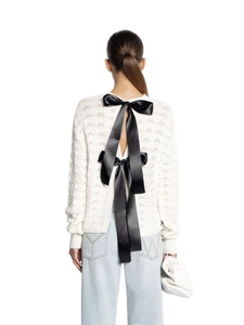 White hollow-out knit cardigan featuring a large black satin bow tie on the back view