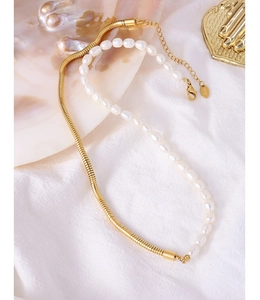 Close-up of 18K gold snake chain necklace with pearl and K18 hallmark detail