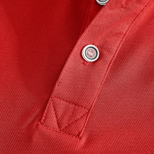Close-up of red piqué fabric texture and neat collar button stitching on polo shirt