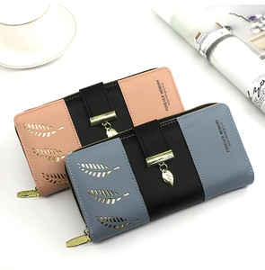 Close-up of bicolor PU leather long wallet with hollow leaf design and metal pendant