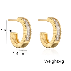 Detail view of gold C-shaped earrings with clear zircon stones and 1.5cm size specs