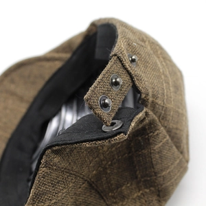 Brown linen beret cap with adjustable metal snap button closure and textured fabric