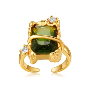 Macro detail of gold-plated ring featuring green rectangular zircon and lava-style band
