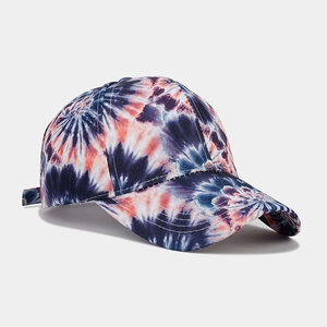 Detail of navy and orange tie-dye baseball cap with cotton twill texture and stitching
