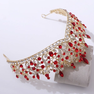 Close-up of gold bridal crown featuring luxury red and white crystal embellishments