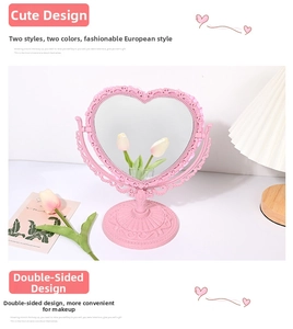 Close-up of pink heart-shaped double-sided vanity mirror in vintage European relief style