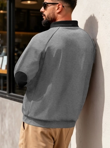 Detailed back view of a grey half-zip sweatshirt with black elbow patches and stand collar