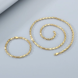 Detail of gold oval link chain necklace and bracelet set with lobster clasp closure