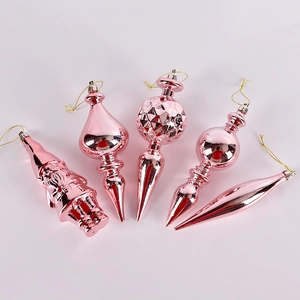 Pink metallic Christmas ornaments set with various festive shapes on white background