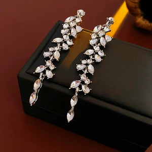 Macro shot of silver tassel earrings with marquise and pear-cut crystal leaf details