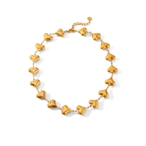 Detailed view of 18K gold plated 3D hollow heart charms on a linked chain necklace