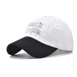 Detailed view of 'keep it simple' embroidery on a two-tone cotton baseball cap