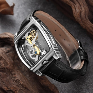 Macro shot of an automatic skeleton watch with silver gears on a dark stone background