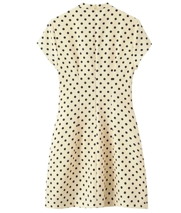 Detail shot of a cream mini dress with black polka dots featuring a stand collar